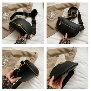 Detail of black lychee grain leather chest bag with golden zippers and wide strap