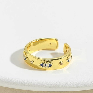 Detail of 14K gold plated adjustable ring featuring enamel evil eye and zircons