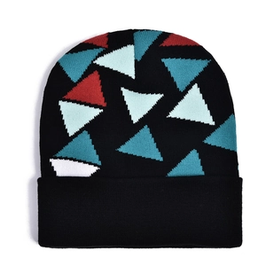 Close-up of black knit beanie featuring vibrant red and blue geometric triangle patterns