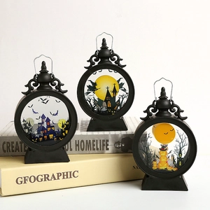 Three black Halloween lanterns with spooky castle and witch silhouettes and LED candle glow