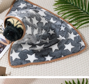 Detail of gray flannel pet blanket with white stars on a French Bulldog model