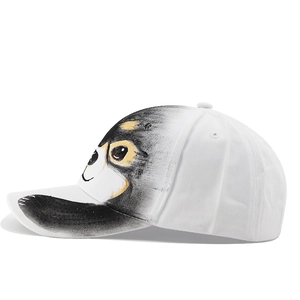 Side view detail of a cotton baseball cap with a printed black and yellow cartoon dog