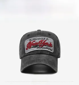 Close-up of vintage washed grey cotton baseball cap with red New York embroidery detail