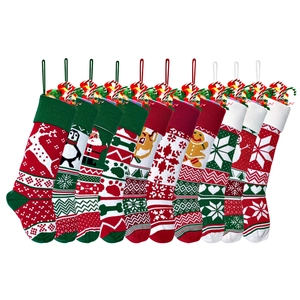 Detailed close-up of colorful knitted Christmas stockings with reindeer and snowflake patterns
