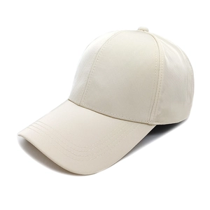 Detail of a beige quick-dry baseball cap with fine texture and four-row visor stitching