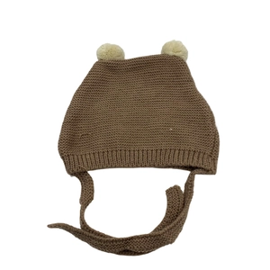 Brown knitted baby hat with dual cream pom-poms and chin straps for winter warmth