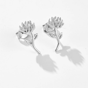 Detailed view of silver floral stud earrings featuring intricate petal and leaf craftsmanship