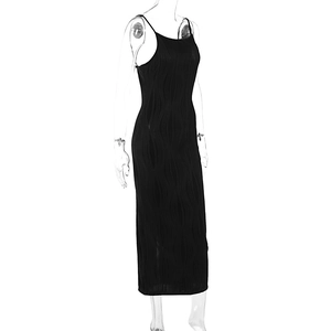 Detail of black bodycon midi dress featuring sleek spaghetti straps and wavy ribbed texture