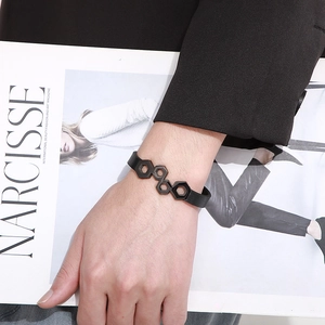 Close-up of black braided leather rope bracelet with geometric hexagonal stainless steel detail