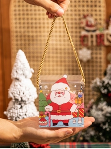 Close-up of a festive transparent Christmas gift box for apples with a golden handle