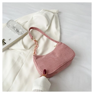 Pink corduroy shoulder bag with gold metal rings and acrylic chain decoration