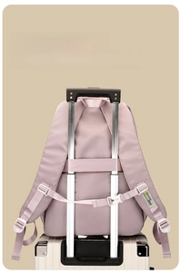 Pink school backpack featuring a back luggage strap for secure suitcase attachment