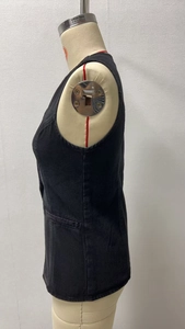 Detailed side profile of a slim fit washed black denim vest on a mannequin display