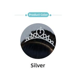 Close-up of silver princess crown headband with heart rhinestone and sparkling drop pendant