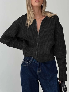 Detail of a dark grey zip-up knit cardigan showing wool blend texture and a slim fit cut