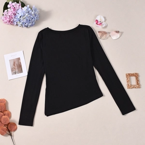 Detail of black long sleeve top featuring asymmetrical hem and ruched chest cutout design