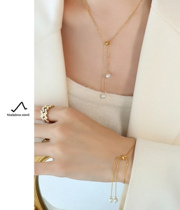 Golden stainless steel jewelry set with pearl necklace, adjustable bracelet and ring