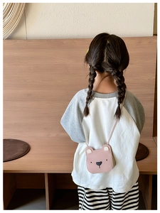 Pink cartoon bear crossbody bag for girls with adjustable strap shown on model