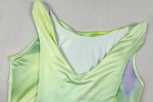 Detail of V-neckline on green and purple gradient sleeveless satin dress with smooth texture