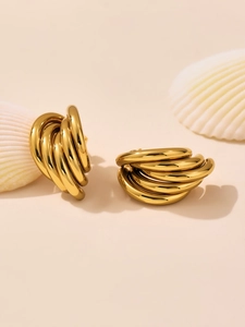 Detail of 18k gold plated stacked water drop hoop earrings on shell backdrop