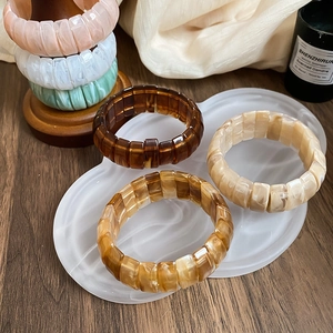 Macro view of multi-color resin elastic bracelets with marble and tortoiseshell patterns