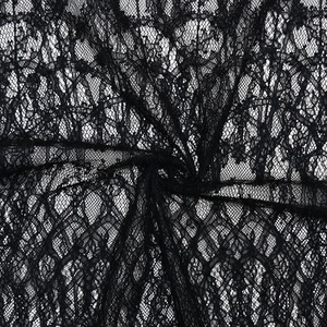 Close-up of black floral lace fabric showing delicate mesh texture and sheer details