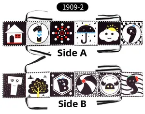 Macro view showing double-sided black and white high-contrast patterns on soft baby book