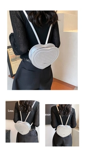 Detail view of heart-shaped backpack with rabbit pattern embossing and silver zipper
