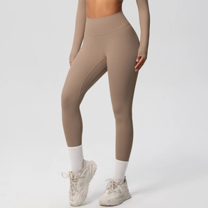 Close-up of high-waist mocha yoga pants and long sleeve top with seamless compression fabric