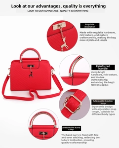 Close-up of red lychee grain leather handbag featuring golden deer pendant and hardware