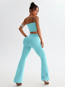 Close-up of light blue ribbed knit yoga set with tube top and high-waist flare pants