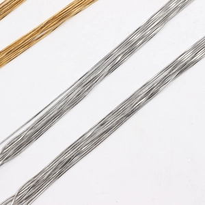 Close-up of gold and silver square snake chains with polished 18K vacuum plating finish