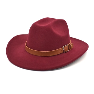 Detailed macro view of wine red wool felt fedora with brown leather belt and metal buckle