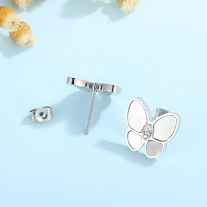 Detailed view of silver butterfly earrings with shell inlay and crystal accents