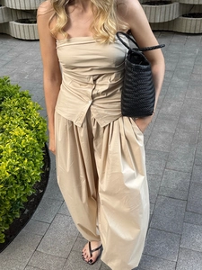 Outdoor shot of a khaki two-piece set with tube top and wide-leg cotton pants
