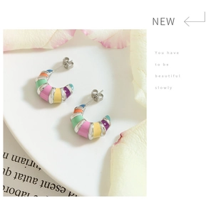 Detailed shot of French retro titanium steel hoop earrings with colorful enamel stripes