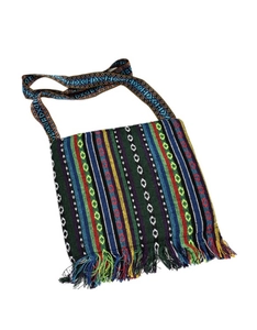 Detail of colorful ethnic crossbody bag featuring woven stripes and vibrant tassel fringe
