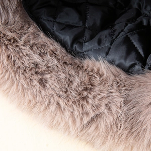 Close-up of quilted black lining and soft faux fox fur texture on the bucket hat edge