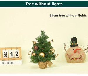 Close-up of a 30cm mini tabletop Christmas tree with gold ornaments and burlap base