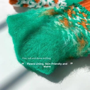 Detail of warm thermal gloves featuring thick fleece lining and green knit texture