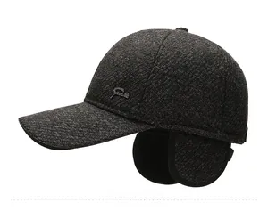Detail of dark gray winter knit baseball cap with ear flaps and Sport metal emblem