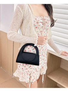 Chic black litchi pattern mini handbag with metal chain strap and unique semi-circle handle