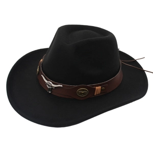 Detail of western cowboy hat with brown faux leather belt and silver bull skull ornament