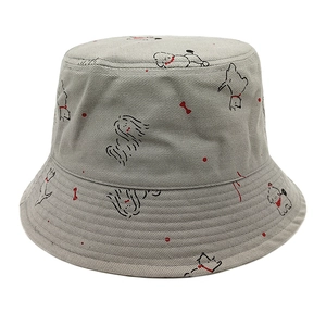 Close-up of gray cotton bucket hat featuring minimalist black puppy print and red dots
