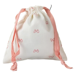 Cream drawstring storage bag with pink bow prints and thick woven cords in a clean studio view