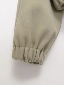 Detail of elastic ribbed cuffs on a thick olive green fleece tracksuit set for women