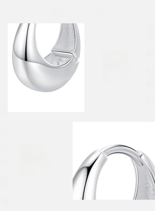 Macro shot of polished S925 sterling silver hoop earrings with high mirror finish texture