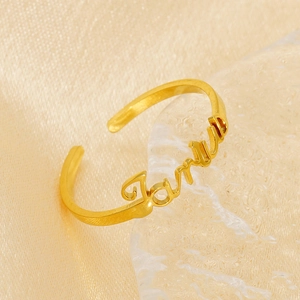 Close-up of golden adjustable stainless steel ring with custom James name design