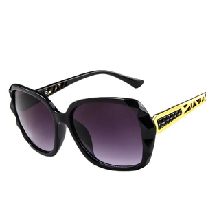 Chic oversized square sunglasses with black faceted frames and gold geometric cutout temples