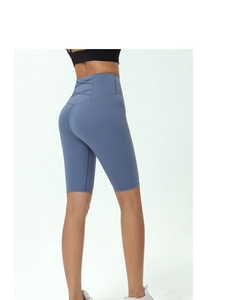 Detail view of high waist yoga shorts in fog blue with stylish cross-strap back design